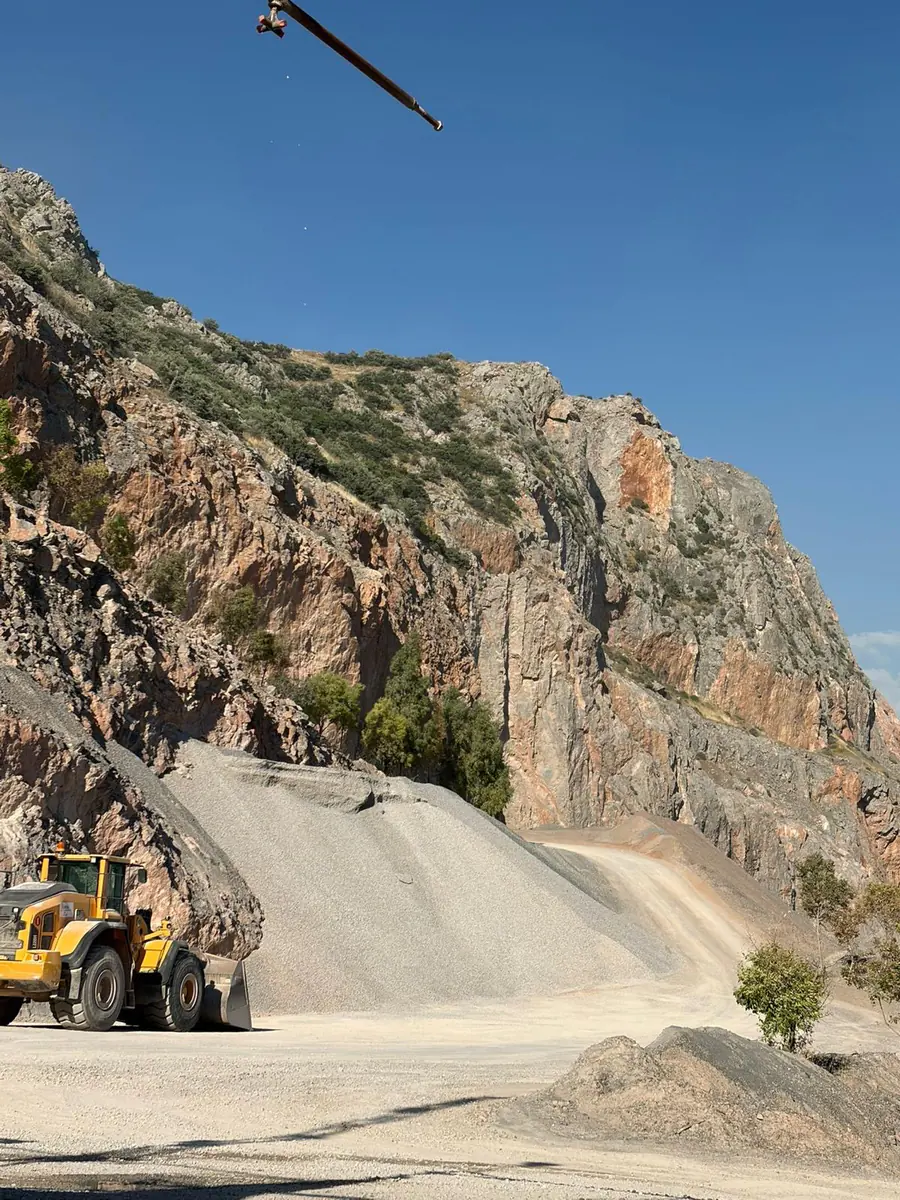 Wheel loader working beside crushed aggregate stockpiles at the İzmir quarry
